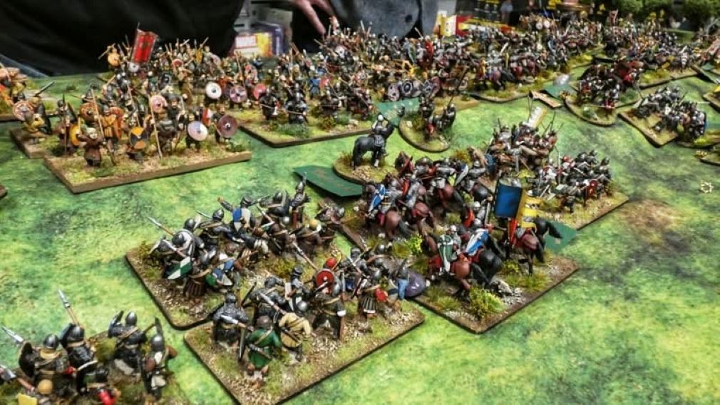 Norman knights and foot
                attack Saxons in 28mm game